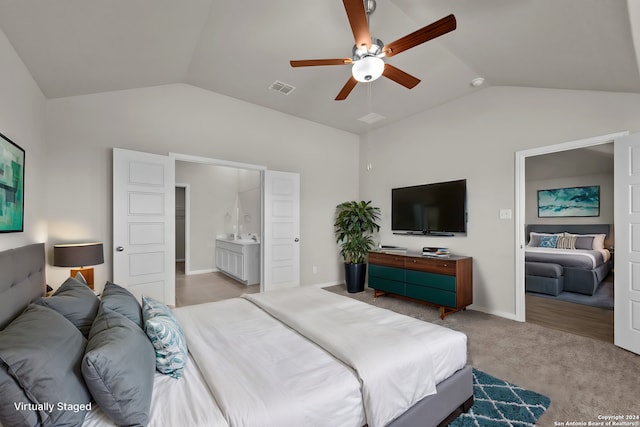 carpeted bedroom featuring ceiling fan, connected bathroom, and lofted ceiling