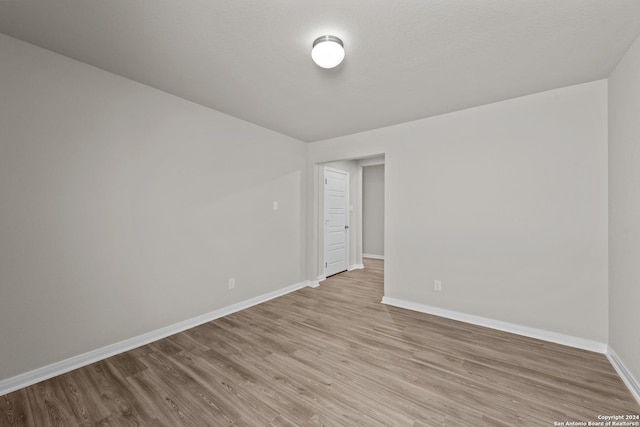 empty room with light hardwood / wood-style floors