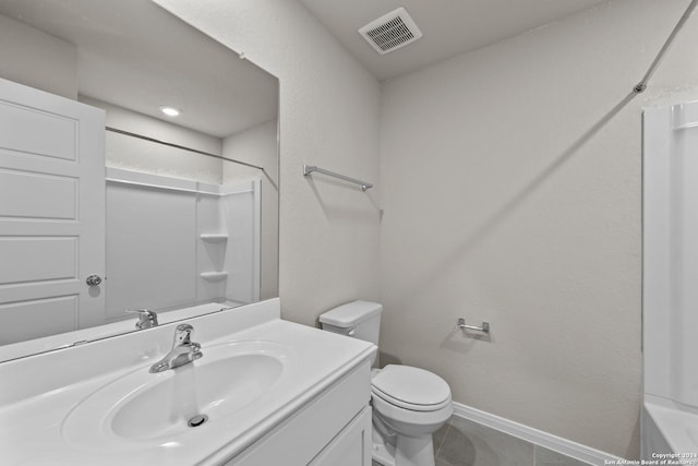 bathroom featuring toilet, tile patterned floors, and vanity