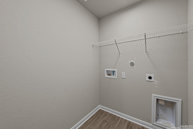 washroom featuring hardwood / wood-style flooring, washer hookup, gas dryer hookup, and hookup for an electric dryer