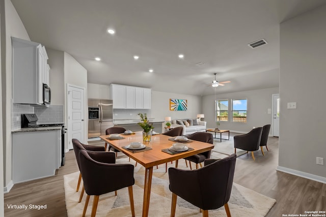 dining space with ceiling fan and light wood-type flooring