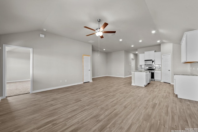 unfurnished living room featuring ceiling fan, lofted ceiling, and light hardwood / wood-style floors