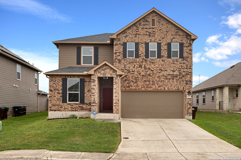 view of front of house featuring a front yard and a garage