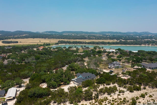 drone / aerial view featuring a water and mountain view