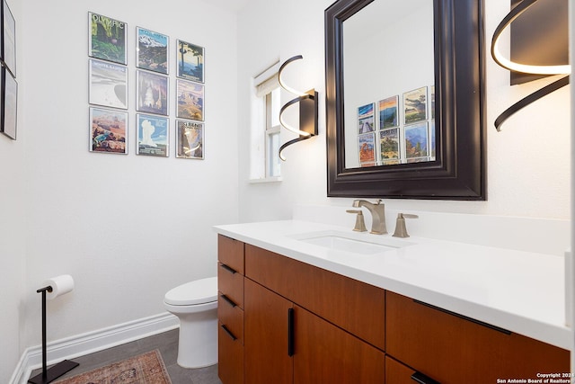 bathroom featuring tile patterned floors, vanity, and toilet