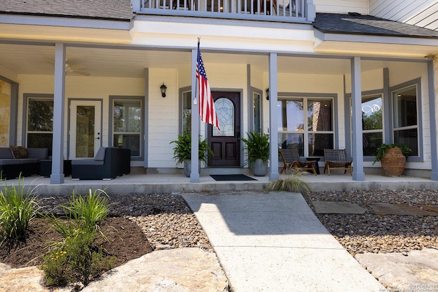 property entrance featuring ceiling fan, a balcony, and covered porch