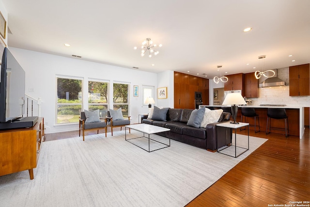 living room featuring hardwood / wood-style floors and a notable chandelier