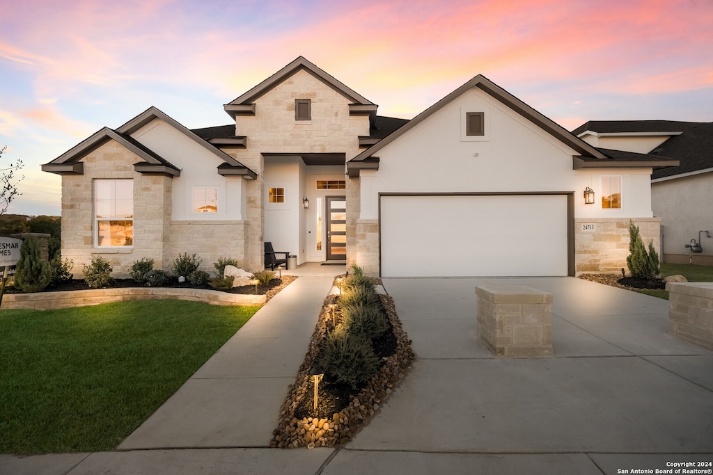 view of front of house with a yard and a garage