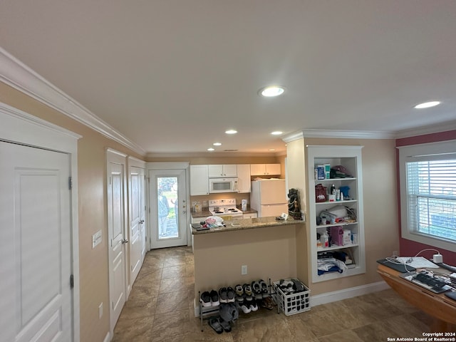 kitchen with crown molding, white appliances, light stone counters, light tile floors, and white cabinets