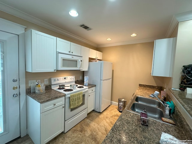 kitchen featuring dark stone countertops, white appliances, white cabinets, sink, and light tile floors