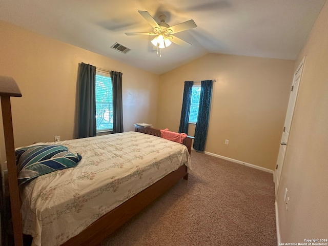 carpeted bedroom with lofted ceiling, multiple windows, and ceiling fan