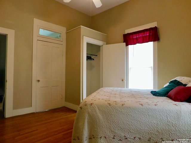 bedroom with a closet, ceiling fan, and dark hardwood / wood-style flooring