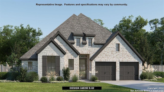 view of front of property featuring a garage and a front lawn