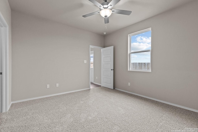 spare room featuring ceiling fan and carpet floors