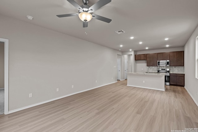 unfurnished living room with ceiling fan and light hardwood / wood-style floors