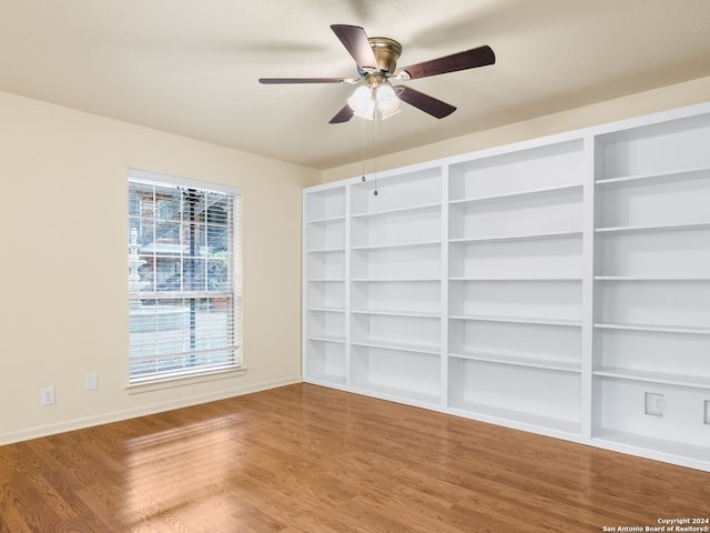 empty room with ceiling fan and hardwood / wood-style flooring