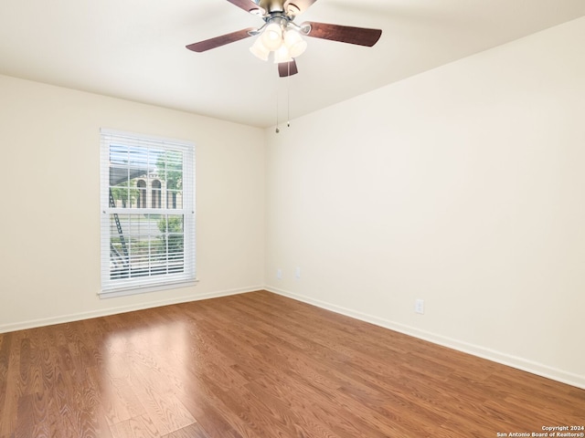 empty room featuring hardwood / wood-style flooring and ceiling fan