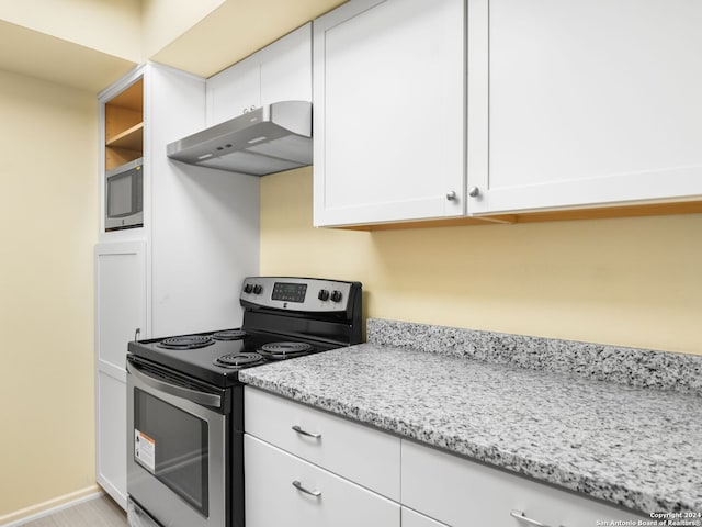 kitchen with light stone counters, white cabinets, and appliances with stainless steel finishes