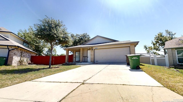 single story home with a garage and a front lawn