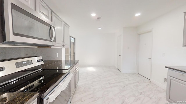 kitchen featuring light tile flooring and stainless steel appliances