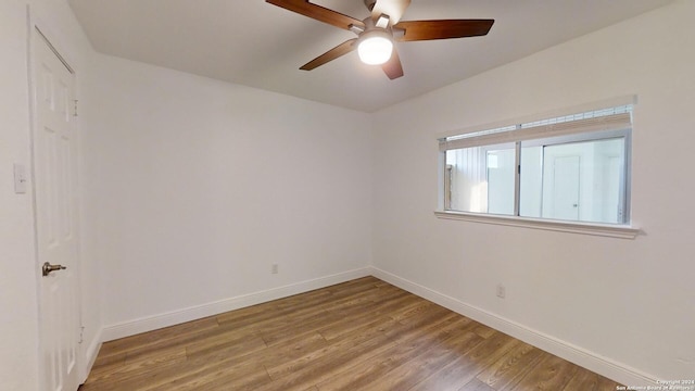 spare room featuring hardwood / wood-style flooring and ceiling fan