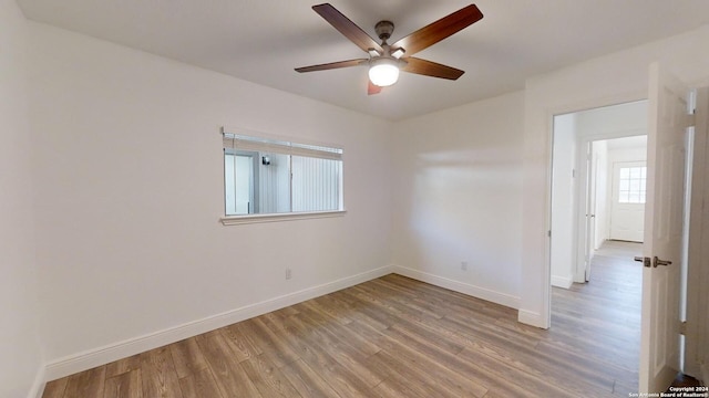 empty room featuring ceiling fan and hardwood / wood-style flooring