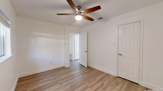 unfurnished bedroom with ceiling fan and light hardwood / wood-style flooring