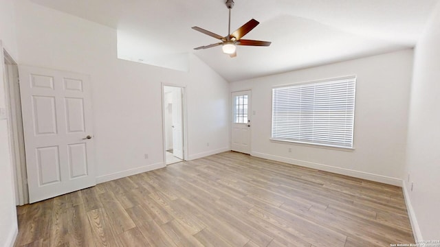 unfurnished room with light hardwood / wood-style floors, high vaulted ceiling, and ceiling fan