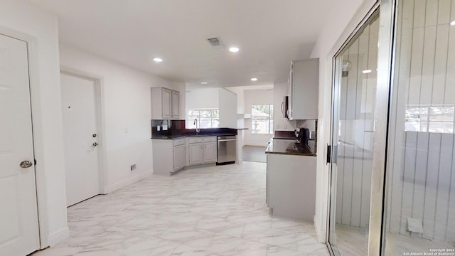 kitchen with appliances with stainless steel finishes, sink, light tile flooring, and gray cabinetry