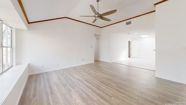 unfurnished room with ceiling fan, hardwood / wood-style floors, a wealth of natural light, and lofted ceiling