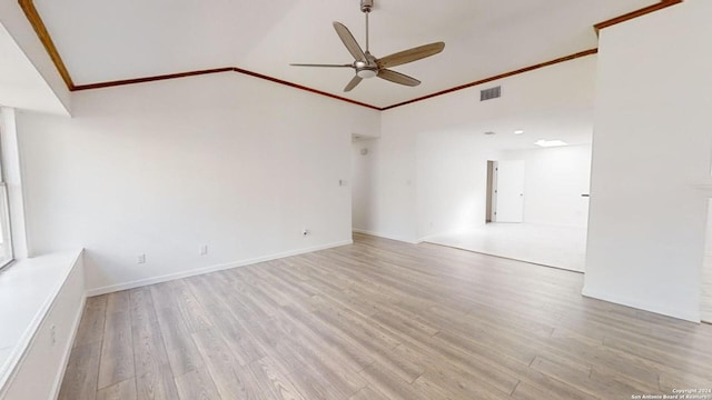 empty room featuring ceiling fan, light hardwood / wood-style floors, and lofted ceiling