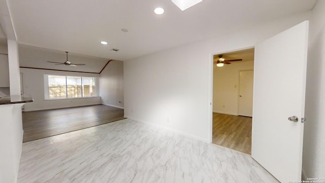 empty room featuring ceiling fan and light hardwood / wood-style flooring