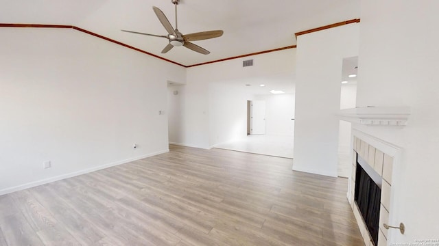 unfurnished living room featuring ceiling fan, crown molding, hardwood / wood-style flooring, and lofted ceiling