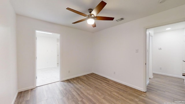 empty room featuring ceiling fan and light wood-type flooring