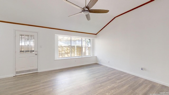 spare room with light hardwood / wood-style floors, ornamental molding, lofted ceiling, and ceiling fan