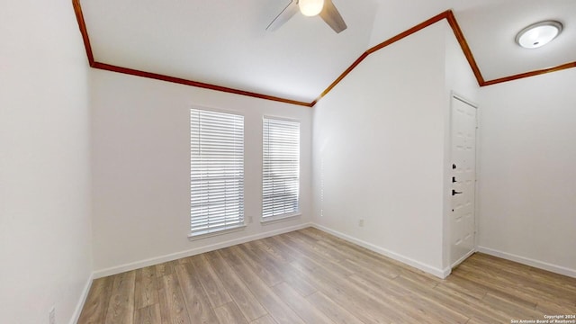 unfurnished room with ornamental molding, light wood-type flooring, vaulted ceiling, and ceiling fan