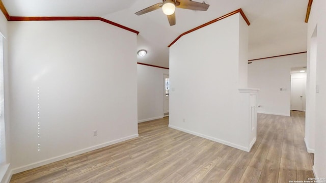 spare room featuring ornamental molding, ceiling fan, light wood-type flooring, and lofted ceiling