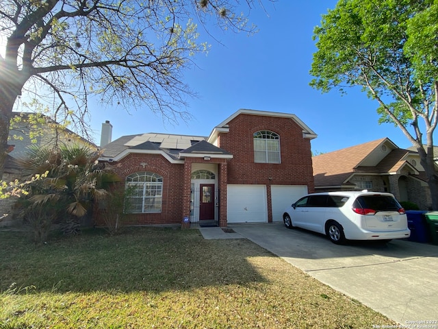 view of property with a front lawn, a garage, and solar panels