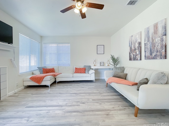 living room featuring wood-type flooring and ceiling fan