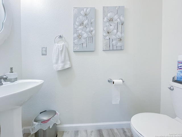 bathroom featuring sink, hardwood / wood-style flooring, and toilet