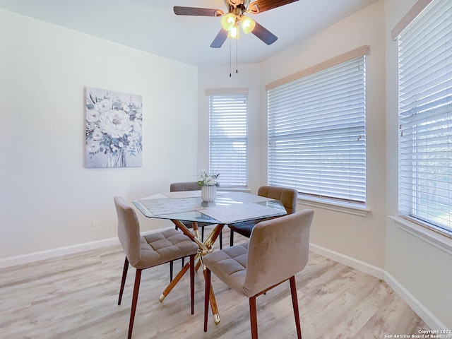 dining area with a healthy amount of sunlight, ceiling fan, and light hardwood / wood-style flooring