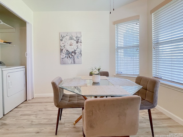 dining room with washer / clothes dryer and light hardwood / wood-style flooring