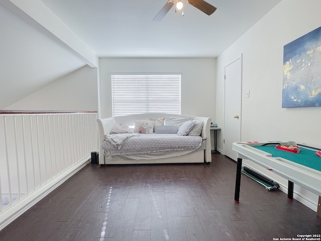 bedroom featuring ceiling fan, dark hardwood / wood-style flooring, and lofted ceiling with beams