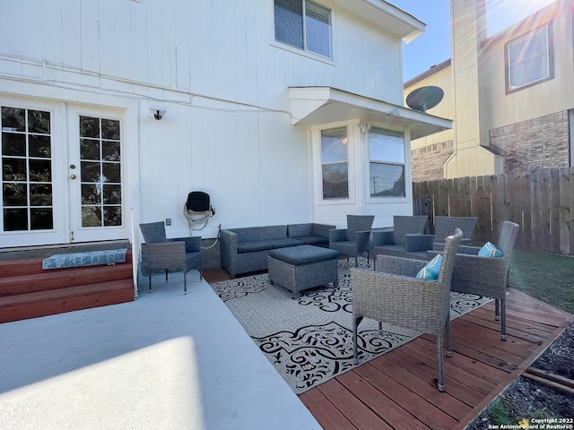 wooden terrace featuring outdoor lounge area, french doors, and a patio area