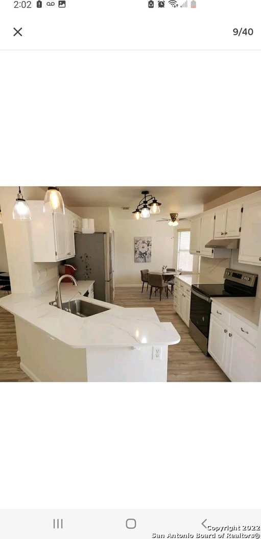 kitchen with sink, light hardwood / wood-style flooring, white cabinetry, and appliances with stainless steel finishes