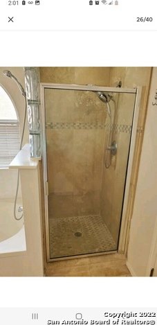 bathroom featuring an enclosed shower