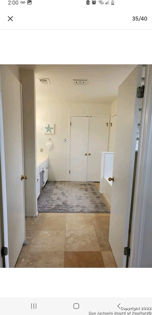 bathroom featuring vanity and tile floors