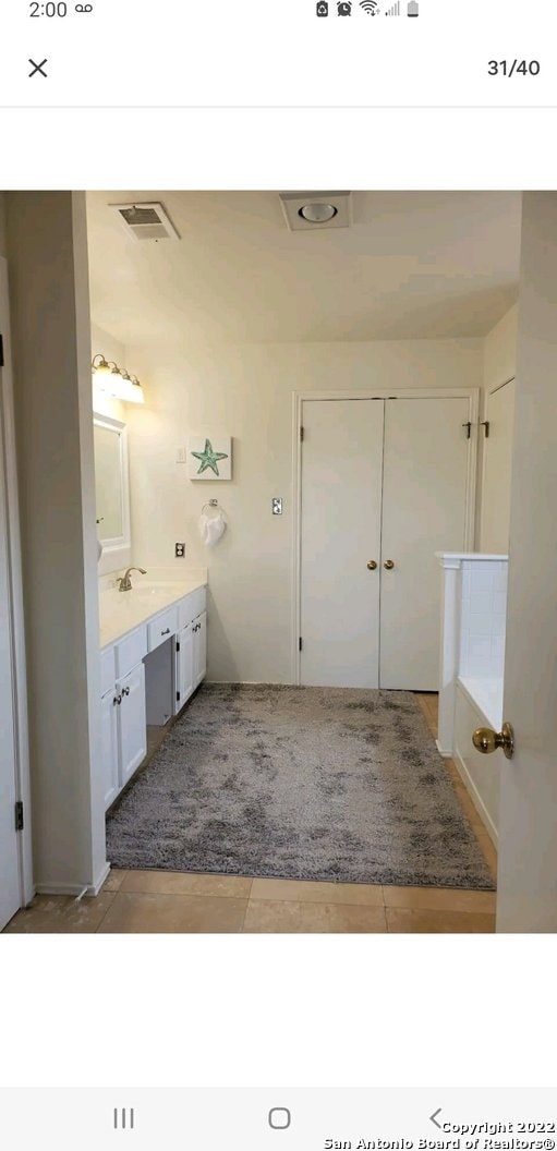 bathroom with tile floors and vanity