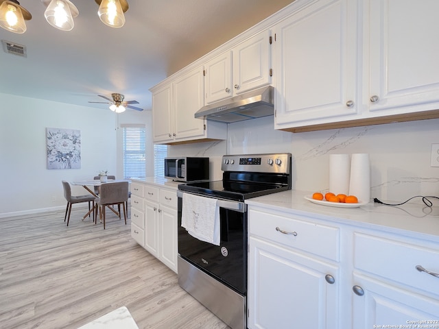 kitchen featuring light stone counters, light hardwood / wood-style floors, ceiling fan, white cabinetry, and appliances with stainless steel finishes