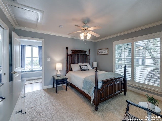 carpeted bedroom with ceiling fan and ornamental molding